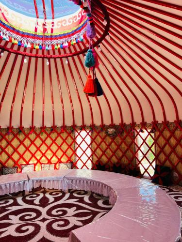 a inside of a yurt with a table in it at Asylai Guesthouse in Naryn
