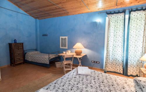 a bedroom with two beds and a table with a desk at Agriturismo Borgo Spagnoli in Magione