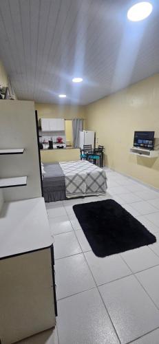 a room with a room with a bed and a couch at Meu lugar! in Manaus