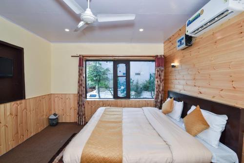 a bedroom with a large bed with a window at Hotel Iceland in Srinagar