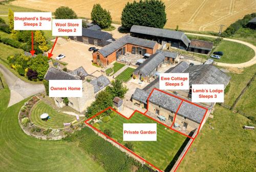 an aerial view of a house with many roofs at Mickleton Hills Farm Cotswold Holiday Cottages in Chipping Campden