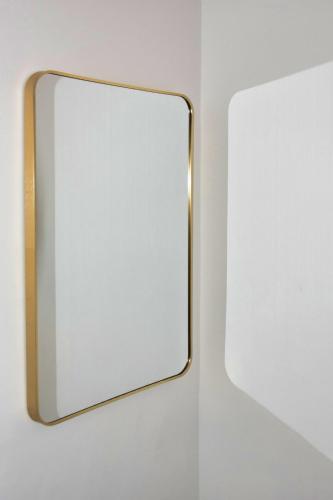 a mirror on a wall with a white wall at White Majorelle Founty in Agadir