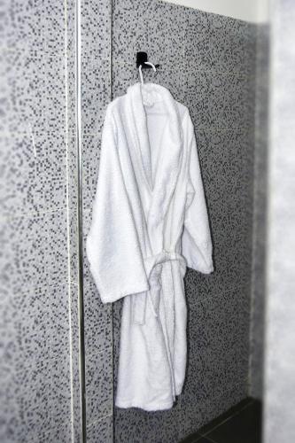 a white robe is hanging on a wall at White Majorelle Founty in Agadir