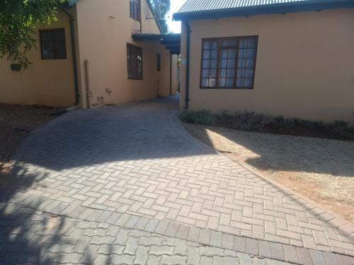 a brick driveway in front of a building at 77 Pendleberry Grove in Warmbaths