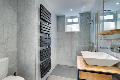 a bathroom with a sink and a shower and a toilet at St Judes in The Mumbles
