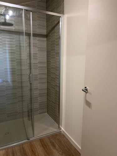 a shower with a glass door in a bathroom at Casa da Vezeira - Gerês in Soengas