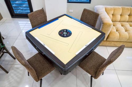 a table with chairs and a laptop on top of it at Tian Central Light Brigade in Wujie