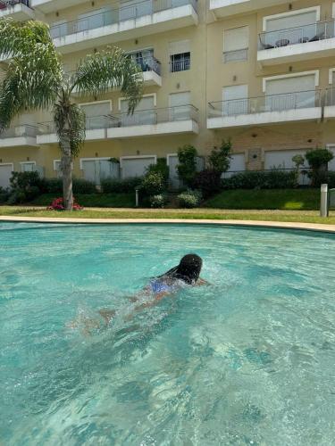 a person swimming in a swimming pool in a building at Résidence kettani in Zemmour Touirza