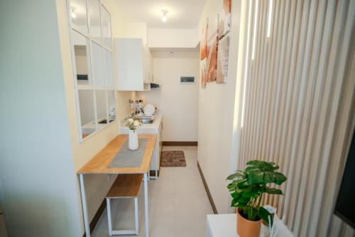 ダバオシティにあるCozy 1BR with 3 Balconies across Roxas Night Marketの小さな部屋に小さなキッチン(テーブル付)が備わります。