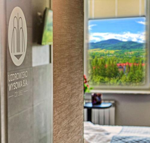 a hotel room with a view of a window at Ośrodek Uzdrowiskowy Biawena in Wysowa-Zdrój