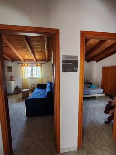 a living room with a bed and a room with a door at Dimora Veronica in Terrauzza