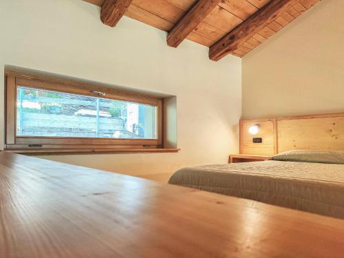 a bedroom with a large window and a bed at ai Parlenti 25 - openspace in Tirano