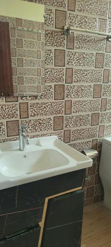 a bathroom with a sink and a toilet at OZY Homestay in Rāiwāla