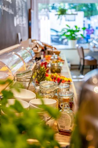 a long table with jars and other items on it at Auto-Parkhotel Hamburg St Pauli in Hamburg