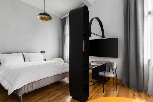 a bedroom with a black and white bed and a desk at IL CONFORMISTA Casa Storica in Thessaloniki