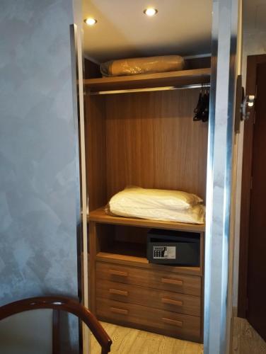 a small closet with a bed in it at Hotel Continental in Turin