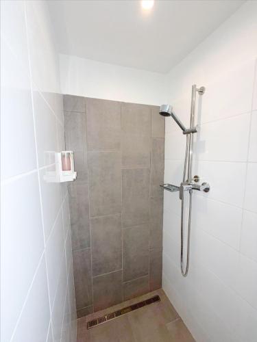 a shower with a glass door in a bathroom at Aruba Palms Escape Suites in Palm-Eagle Beach