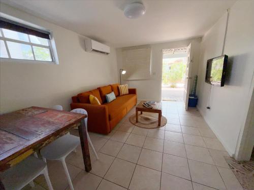 a living room with a couch and a table at Aruba Palms Escape Suites in Palm-Eagle Beach