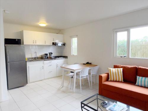 a living room with a couch and a table at Aruba Palms Escape Suites in Palm-Eagle Beach