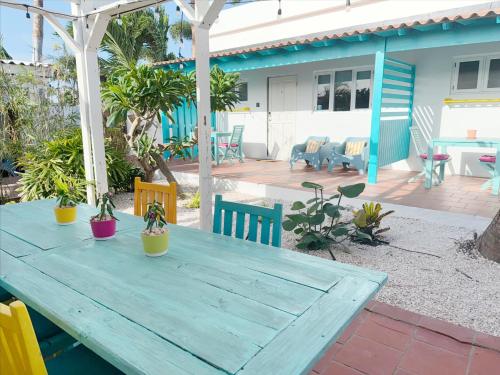 a wooden table with potted plants on a patio at Aruba Palms Escape Suites in Palm-Eagle Beach