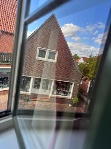 a view of a brick house from a window at Greetsieler Börse in Greetsiel