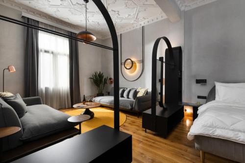 a living room with a bed and a couch at IL CONFORMISTA Casa Storica in Thessaloniki