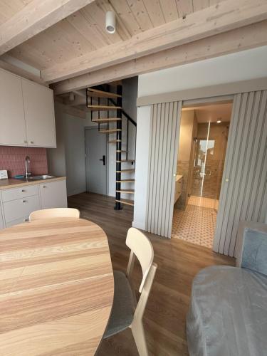 a kitchen and dining room with a table and a staircase at Port Rewa in Rewa