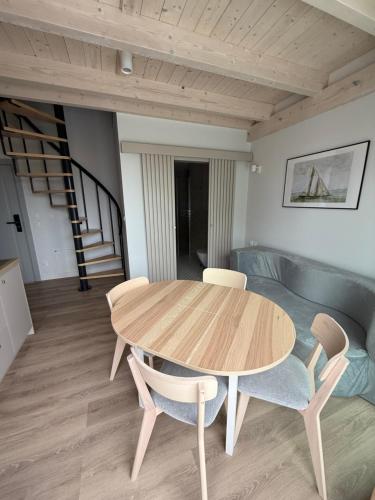 a wooden table and chairs in a living room at Port Rewa in Rewa
