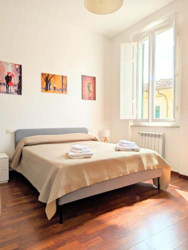 Ένα ή περισσότερα κρεβάτια σε δωμάτιο στο Tuscany Home Montecatini Centro