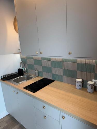 a kitchen with white cabinets and a sink at Port Rewa in Rewa
