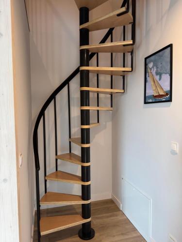 a spiral staircase in a home with white walls at Port Rewa in Rewa