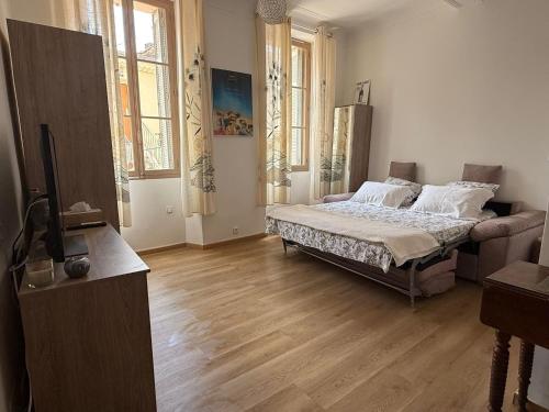 une chambre avec un lit au milieu d'une pièce dans l'établissement Suquet 5 mins à pied du palais, à Cannes