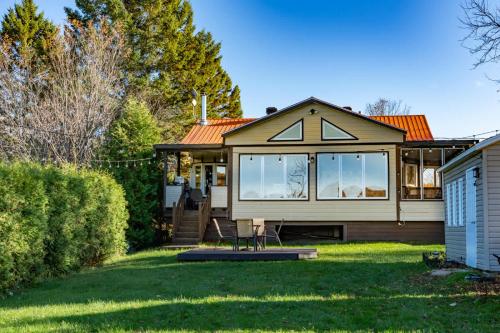 a small house with a lawn in front of it at Lake Nature & Outdoor Fun - Chalet Mandeville II in Mandeville