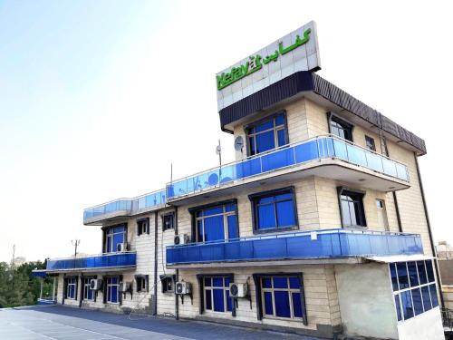 a building with a sign on top of it at Kefayat Hotel in Balkh