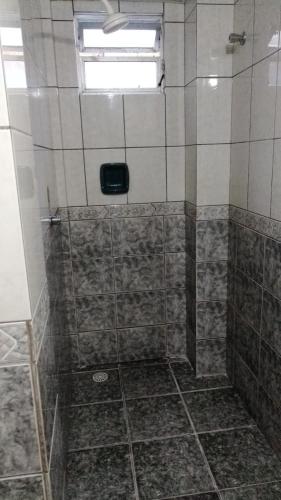a bathroom with a shower with a window at HOTEL LIVRAMENTO Maceió in Maceió