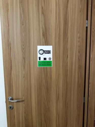 a wooden door with a sticker on it at Beppo's B&B in Carbonia
