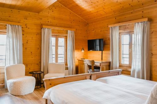 Postel nebo postele na pokoji v ubytování Hôtel de Commune - Rougemont
