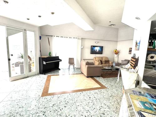 a living room with a couch and a tv at Hotel Pietra Verde in Otranto