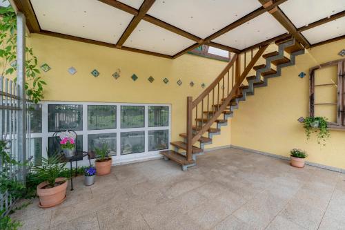 a patio with a staircase in a house at Heimatglück Vulkaneifel in Salm