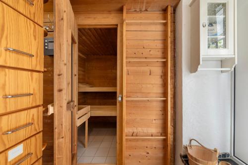 a sauna with a wooden closet in a house at Heimatglück Vulkaneifel in Salm