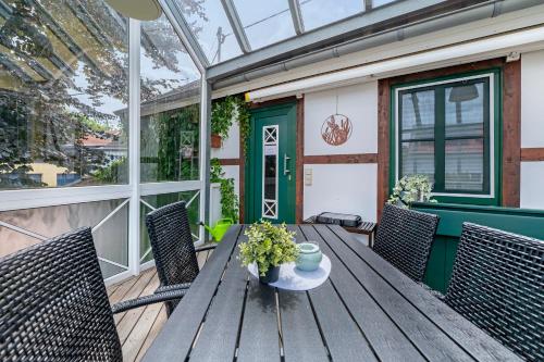 a wooden table and chairs on a patio at Heimatglück Vulkaneifel in Salm