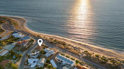 an aerial view of a beach with a road at Absolute Beachfront Escape Family Retreat in Mandurah