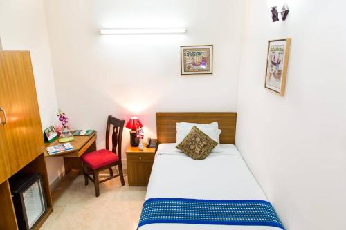 a bedroom with a bed and a desk and a chair at Hotel Shahin Residential Jatrabari in Dhaka