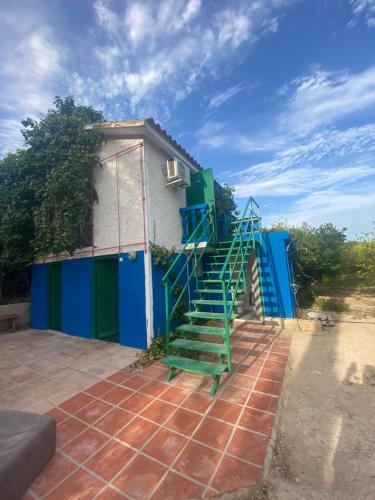 a house with a blue and green staircase on it at Pink Lemon House in Elche