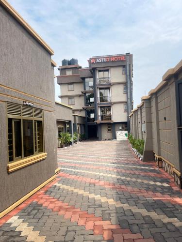 an empty brick street in front of a building at Astro Motel in Nalakonge