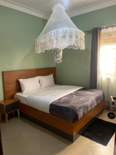 a bedroom with a bed with a chandelier above it at Astro Motel in Nalakonge