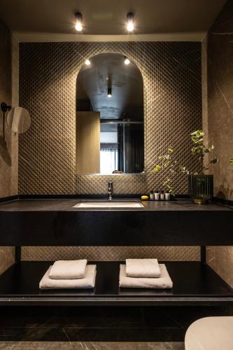 a bathroom with a sink and a mirror at Heritage Hill Hotel in Athens