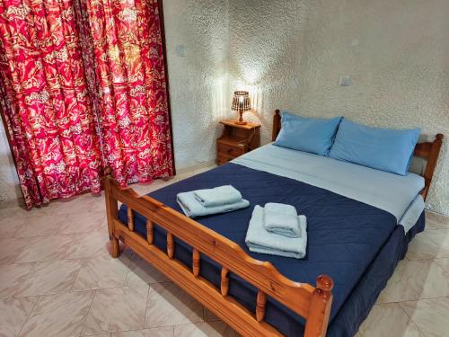 a bedroom with a bed with towels on it at Akrata Golden Beach House in Aíyira