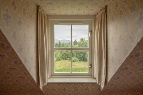 a window in a room with a view at Laggandhu in Nethy Bridge