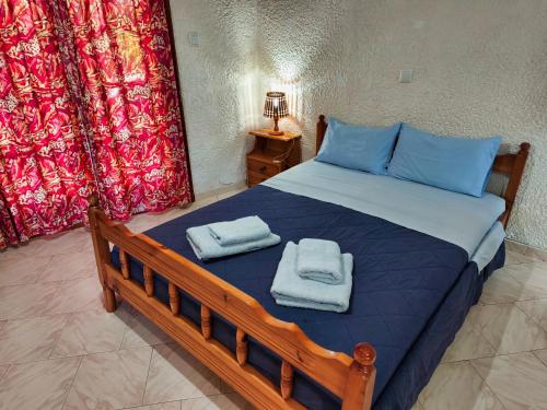 a bedroom with a bed with towels on it at Akrata Golden Beach House in Aíyira